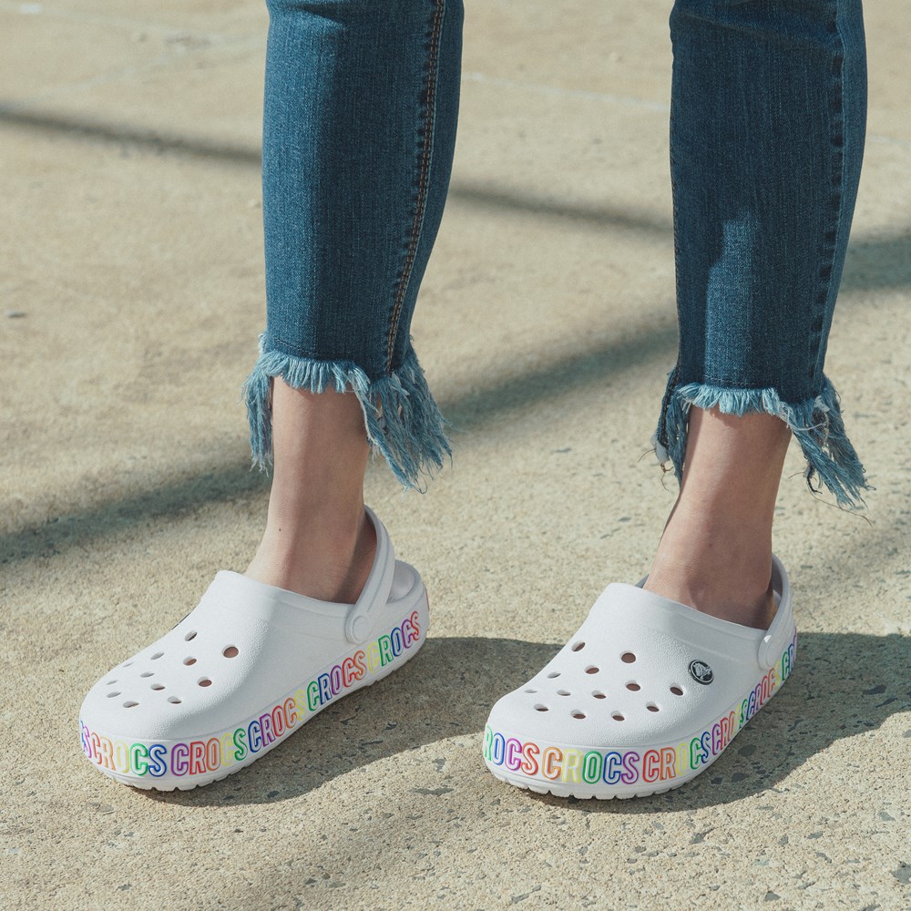 white crocs with rainbow lettering